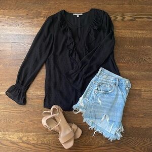 Black top with ruffle detail